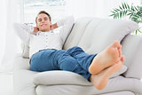 Full length of a relaxed young man lying on sofa