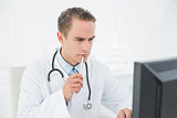 Doctor looking at computer at medical office