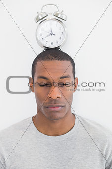 Man with an alarm clock on top of his head