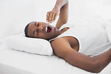 Sleepy Afro man yawning in bed