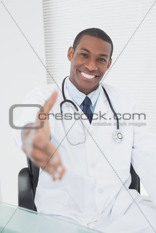 Doctor offering a handshake at medical office