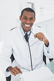 Male doctor sitting at desk in medical office