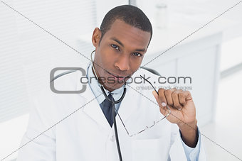 Serious male doctor in medical office