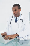 Doctor using laptop at medical office