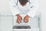 Overhead view of a male doctor using laptop