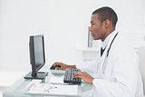Concentrated doctor using computer at medical office