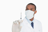 Male doctor in mask and glove holding an injection