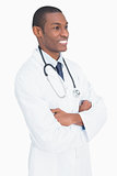 Smiling male doctor standing with arms crossed