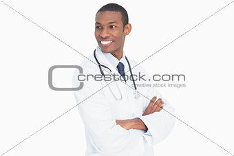 Smiling male doctor standing with arms crossed