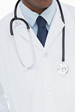 Mid section of a male doctor in lab coat and with stethoscope