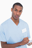 Portrait of a serious male surgeon with clipboard