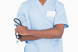 Close up mid section of a male surgeon holding stethoscope