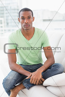 Portrait of a relaxed Afro man sitting on sofa