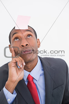 Afro businessman with blank note on forehead