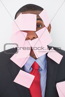 Close up portrait of Afro businessman covered in blank notes