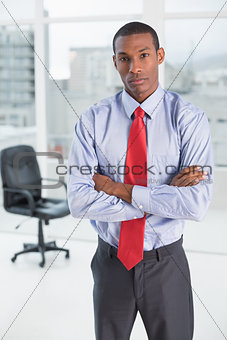 Elegant serious Afro businessman in office
