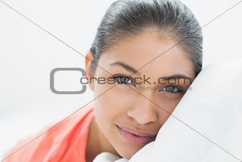 Pretty young woman resting in bed