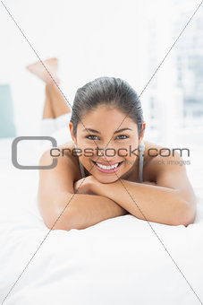 Portrait of a pretty woman lying in bed