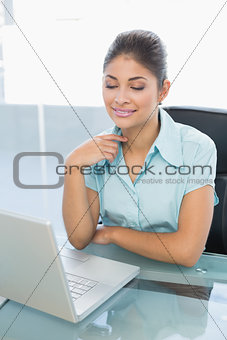 Relaxed businesswoman with eyes closed using laptop in office