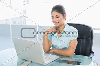 Relaxed businesswoman with eyes closed using laptop