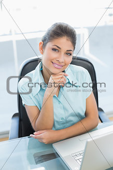 Portrait of businesswoman with laptop at office