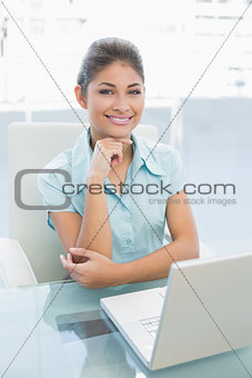 Elegant businesswoman with laptop at office