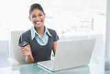 Portrait of a smiling businesswoman doing online