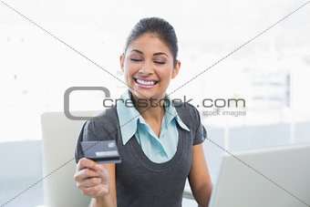 Smiling businesswoman doing online shopping