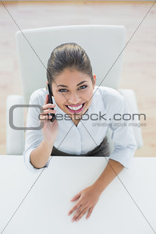 Smiling elegant businesswoman using cellphone