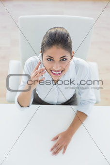Smiling elegant businesswoman using cellphone