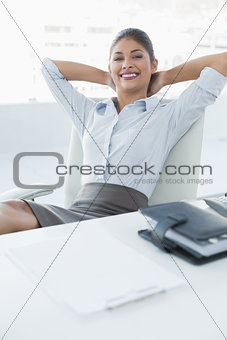 Relaxed businesswoman sitting in office