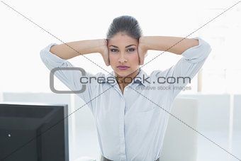 Young businesswoman suffering from headache in front of computer