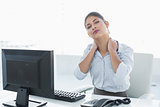 Businesswoman with neck pain in front of computer