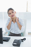 Businesswoman with neck pain in front of computer