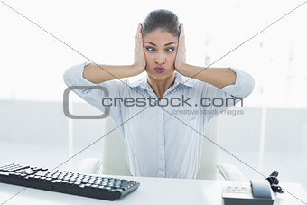 Businesswoman suffering from headache in front of computer at office
