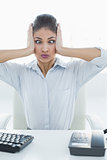 Businesswoman suffering from headache at office