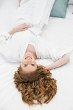 Overhead portrait of pretty woman resting in bed