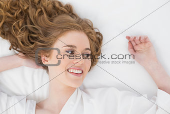 Overhead view of a smiling young blond in bed
