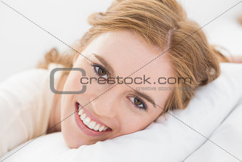 Close up of pretty young woman resting in bed