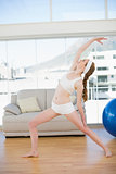 Sporty woman stretching hand in fitness center