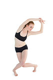 Full length of a sporty woman stretching