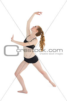 Full length of a sporty young woman stretching