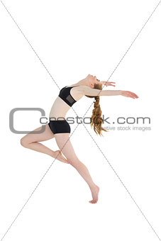 Side view of a sporty young woman stretching