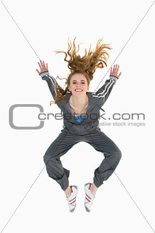 Full length of a sporty young blond jumping