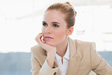 Thoughtful businesswoman in bright office