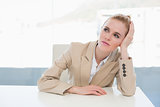 Thoughtful businesswoman sitting at office desk