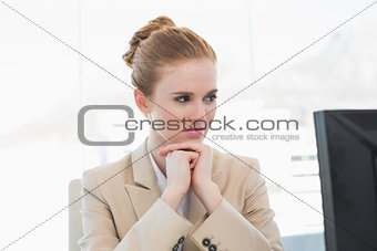 Worried young businesswoman looking at computer