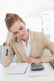 Tired young businesswoman resting at office desk