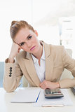 Tired businesswoman sitting at office desk