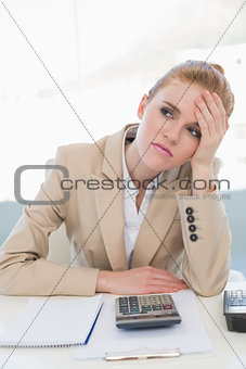 Worried businesswoman sitting at office desk